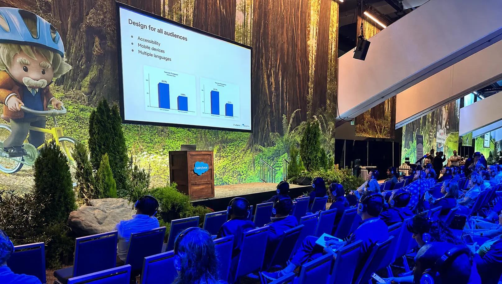 A speaker presenting a slide titled Design for all audiences on the keynote stage